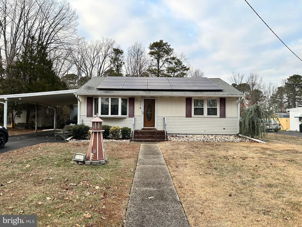 view of front facade with a front lawn and a carport