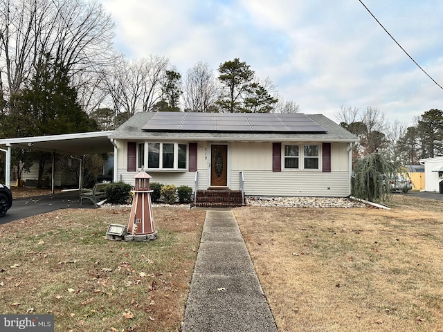 view of front facade with a front lawn and a carport