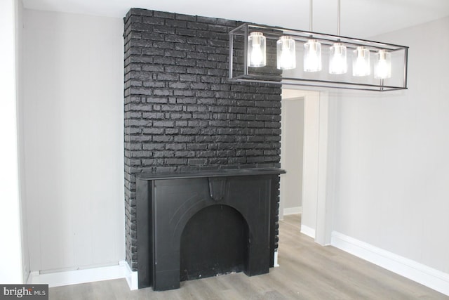 details featuring hardwood / wood-style floors and a brick fireplace