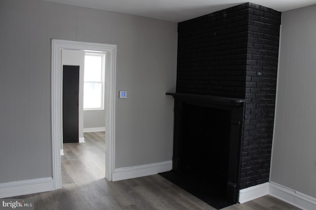 interior space with hardwood / wood-style floors and wood walls