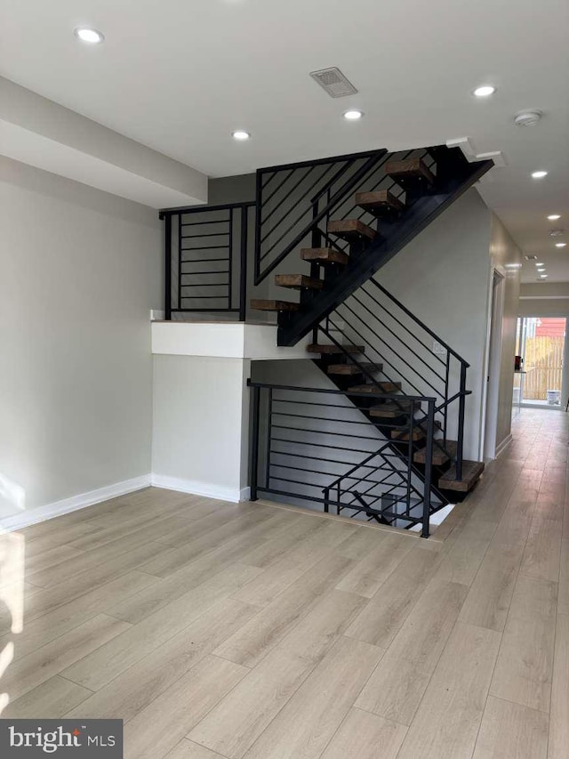 staircase featuring hardwood / wood-style floors