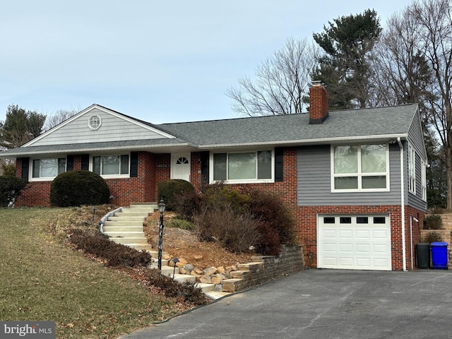 view of front of property with brick siding, a chimney, asphalt driveway, roof with shingles, and an attached garage