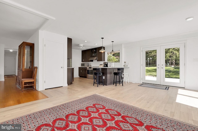 living area featuring french doors, light wood-style flooring, recessed lighting, and a ceiling fan