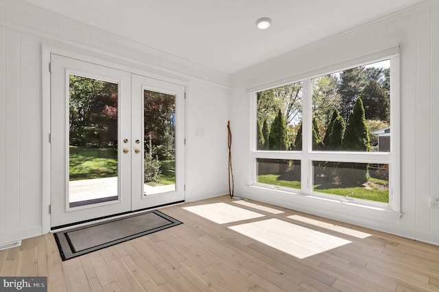 unfurnished sunroom with french doors