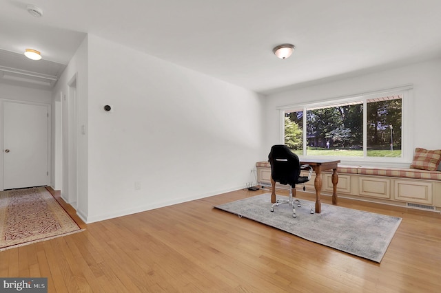 home office with light wood-style floors and baseboards