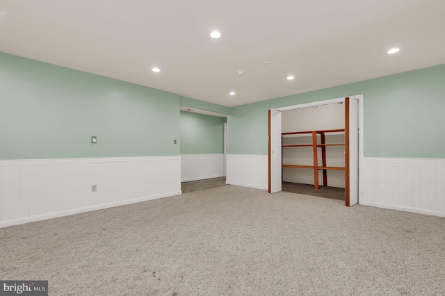 unfurnished room with wainscoting, recessed lighting, and carpet floors