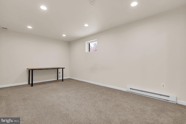 basement with a baseboard radiator, recessed lighting, carpet, and baseboards