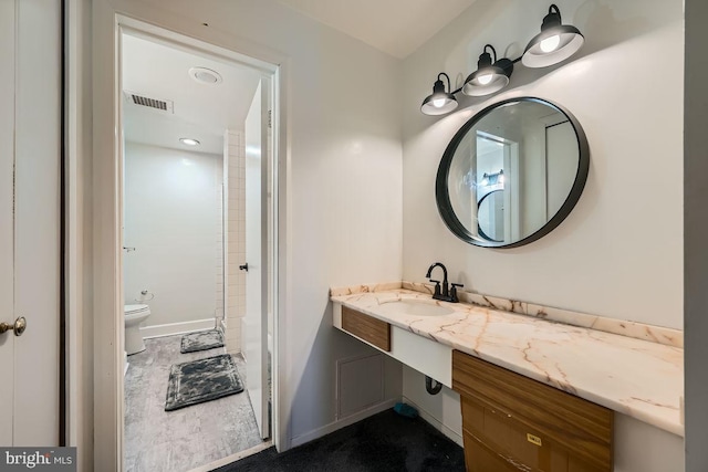 bathroom with toilet and vanity