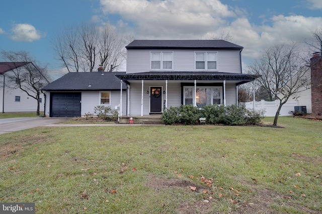 front of property featuring a front yard, a garage, and covered porch