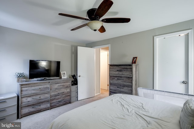 bedroom featuring light carpet and ceiling fan