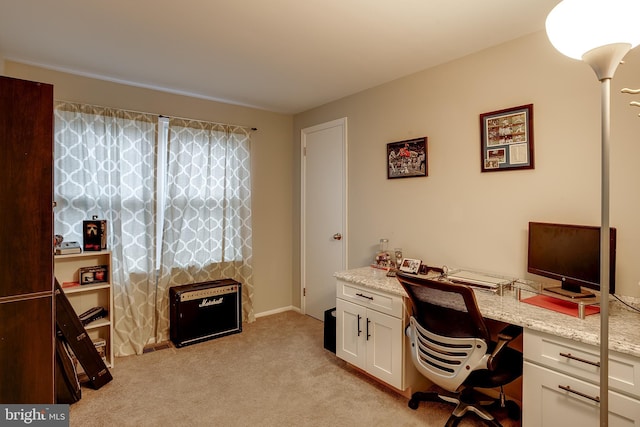 carpeted office featuring built in desk