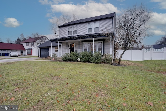 front of property featuring a front lawn, a porch, and a garage