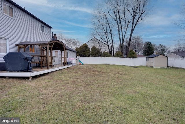 view of yard with a gazebo, a storage shed, and a deck