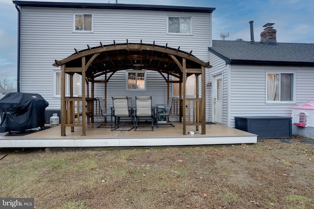 rear view of property featuring a deck