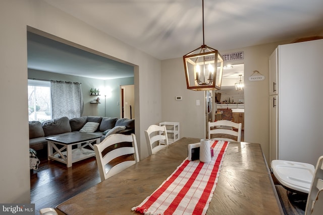 dining room featuring a chandelier and dark wood-type flooring