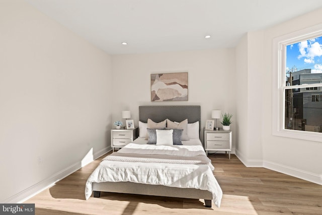 bedroom with hardwood / wood-style flooring