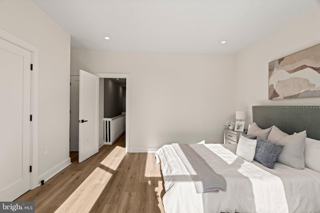 bedroom with hardwood / wood-style flooring