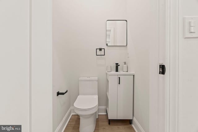 bathroom featuring wood-type flooring and toilet