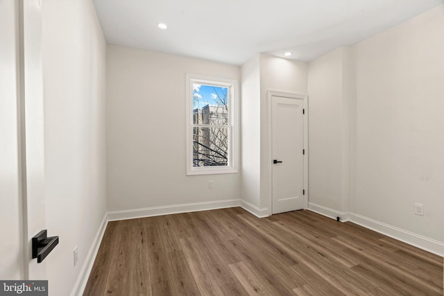 spare room featuring wood-type flooring