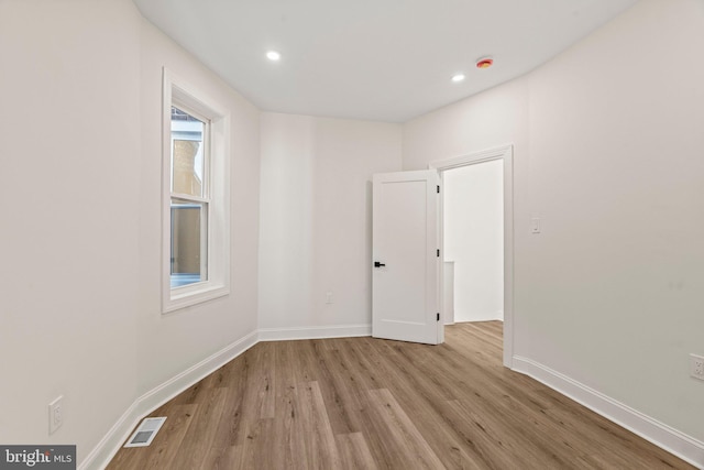 spare room featuring light wood-type flooring