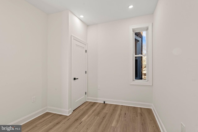 empty room with light hardwood / wood-style flooring