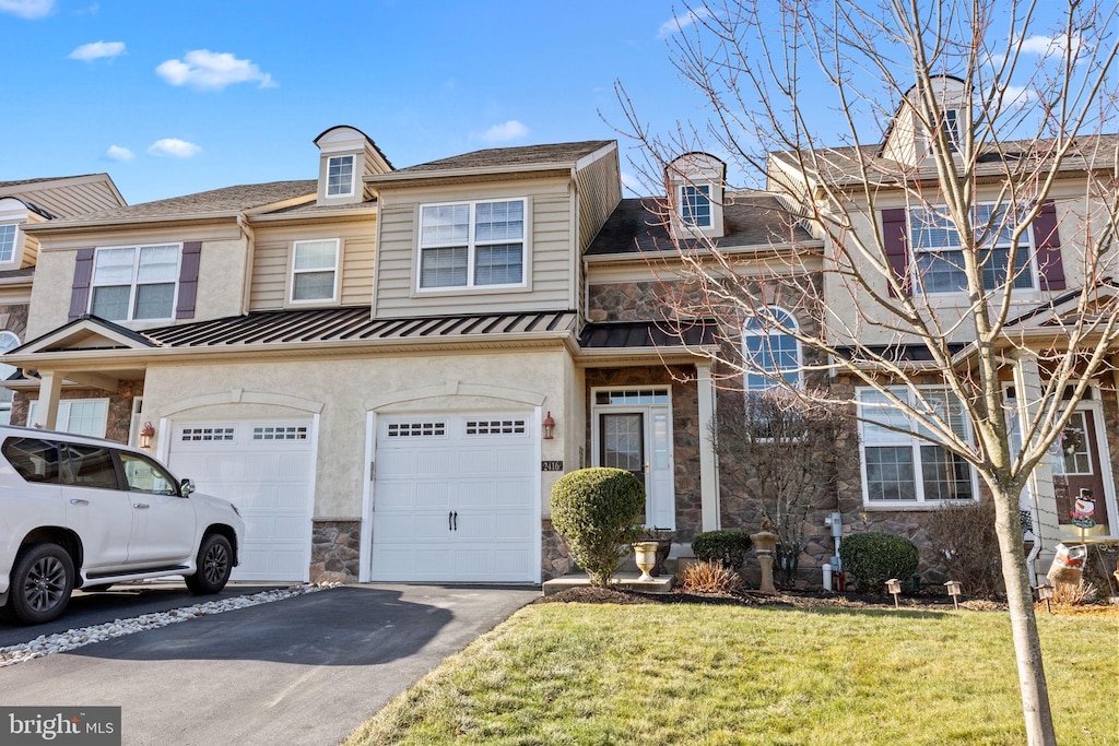 multi unit property featuring a front yard and a garage