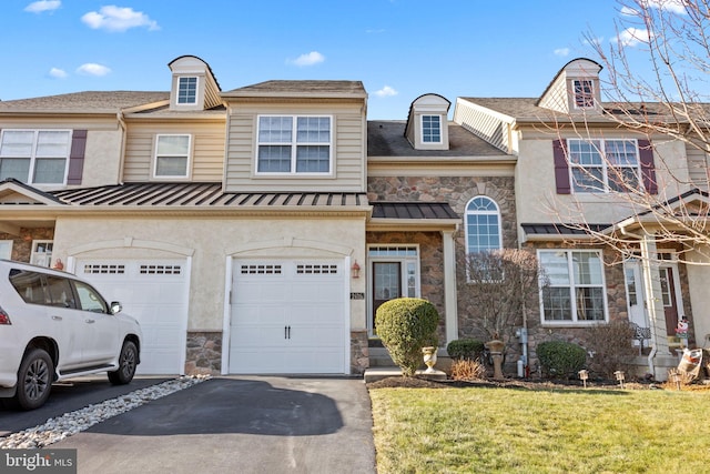 townhome / multi-family property with a front lawn and a garage