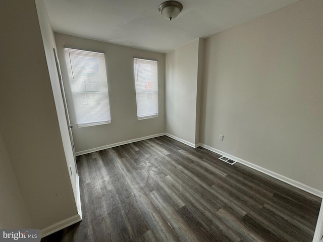 unfurnished room featuring dark hardwood / wood-style floors