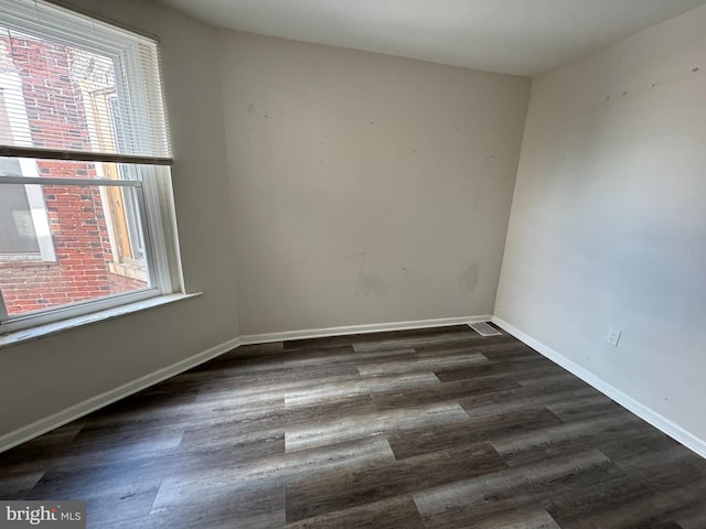 empty room with dark wood-type flooring