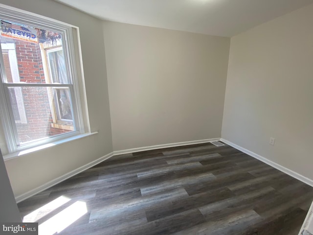 unfurnished room featuring dark hardwood / wood-style flooring