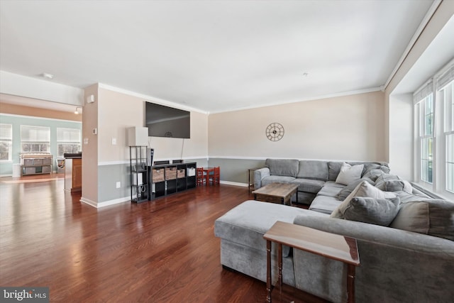 living room with crown molding, dark wood-style flooring, and baseboards