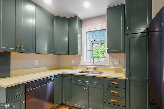 kitchen with dishwasher, sink, and green cabinets