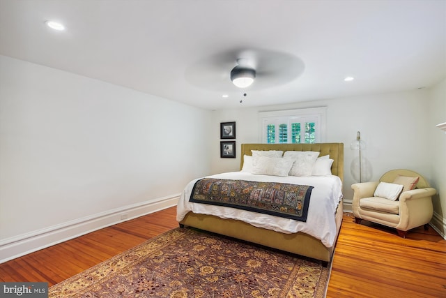 bedroom with ceiling fan and wood-type flooring