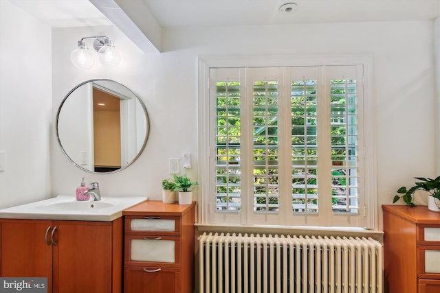 bathroom featuring radiator and vanity