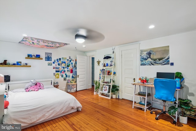 bedroom with ceiling fan and light hardwood / wood-style flooring