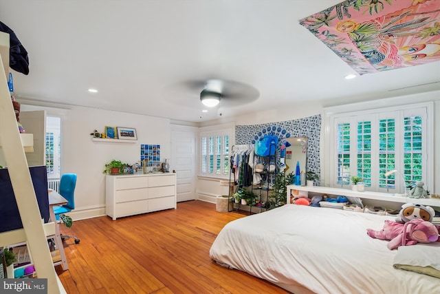 bedroom featuring ceiling fan and light hardwood / wood-style flooring