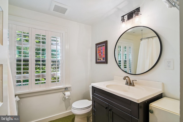 bathroom with toilet and vanity