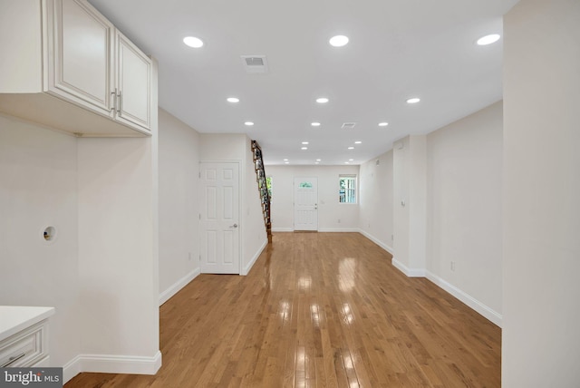 corridor with light hardwood / wood-style flooring