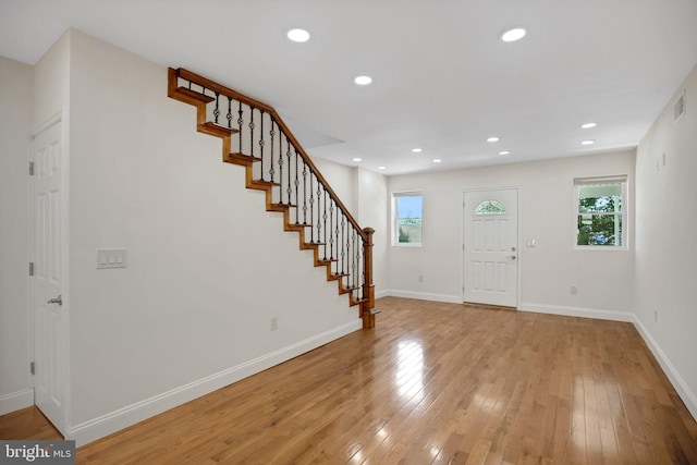 foyer entrance with light hardwood / wood-style floors