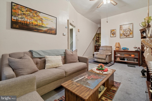 carpeted living room featuring ceiling fan