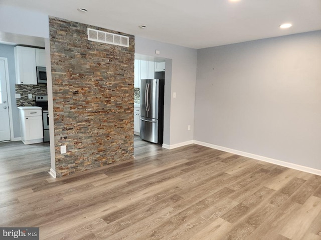 unfurnished living room featuring light hardwood / wood-style floors