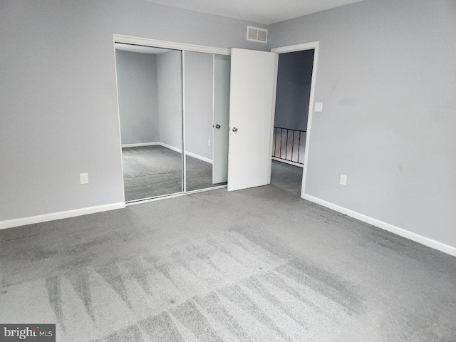 unfurnished bedroom featuring carpet floors and a closet