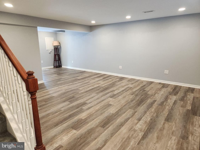 basement with hardwood / wood-style flooring