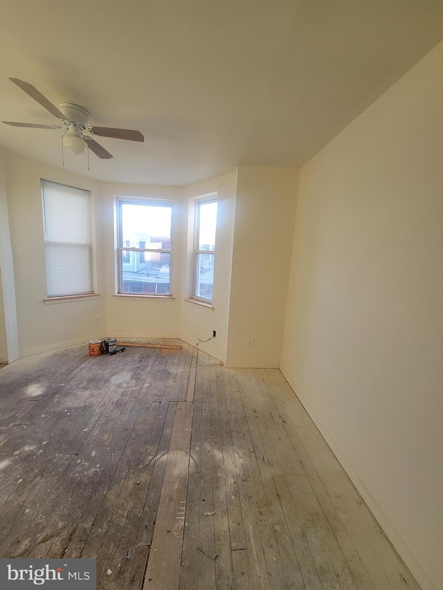 spare room with ceiling fan and light hardwood / wood-style flooring