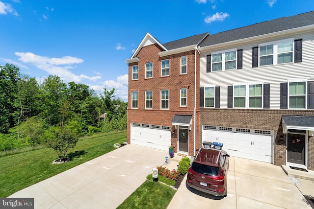 townhome / multi-family property featuring a garage and a front yard