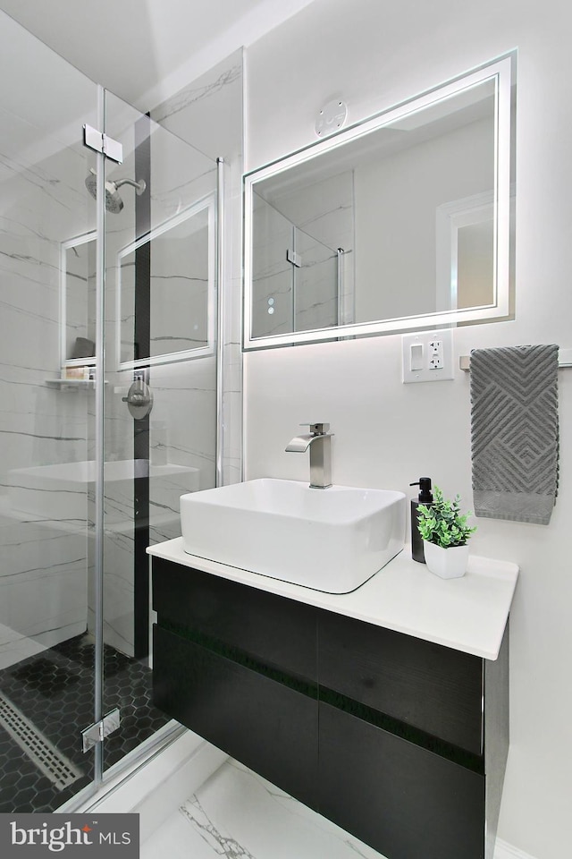 bathroom featuring vanity and a shower with shower door