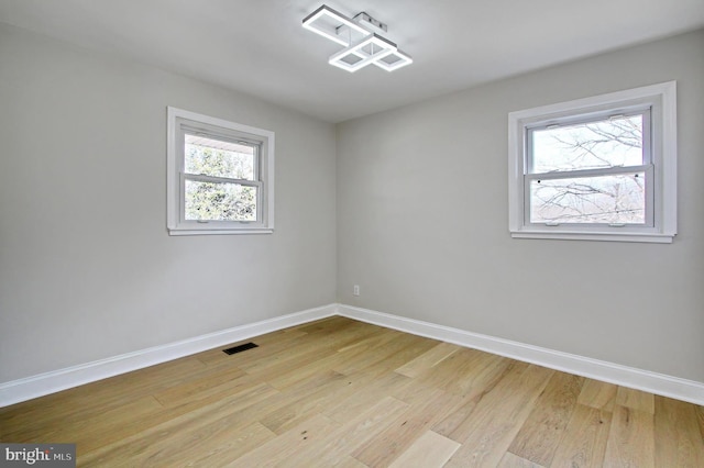 spare room with light hardwood / wood-style flooring