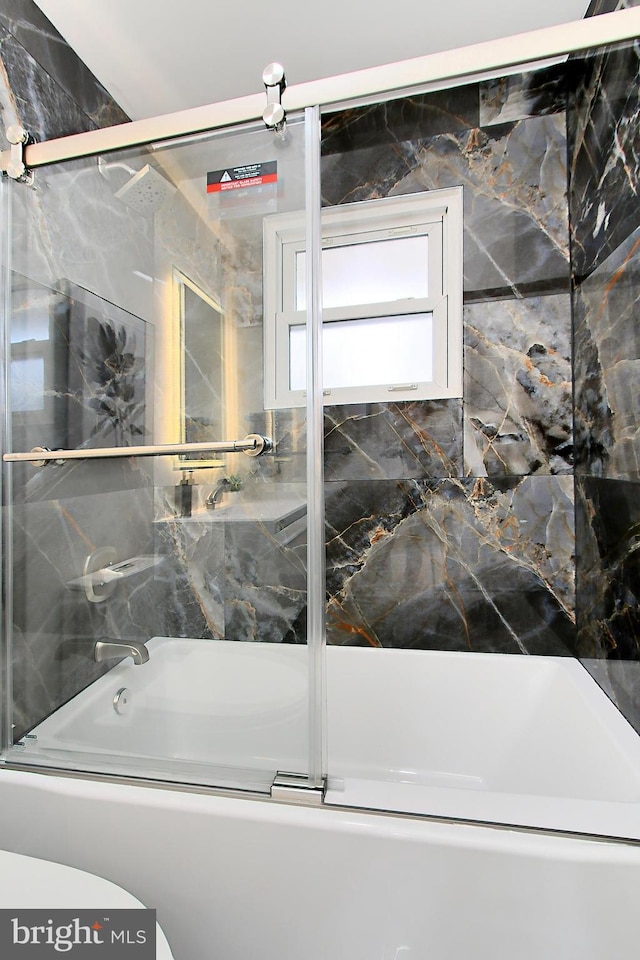 bathroom featuring toilet and enclosed tub / shower combo