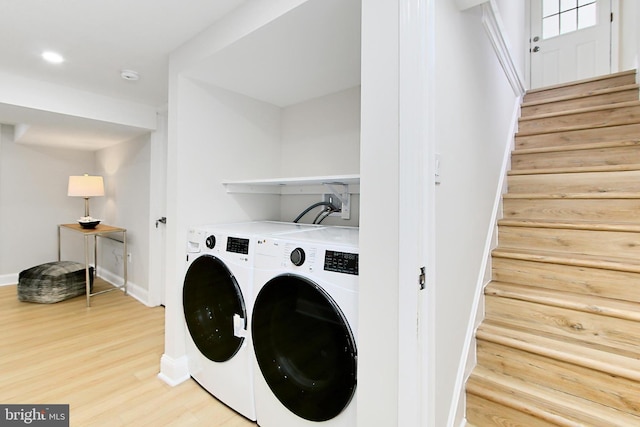 laundry area with hardwood / wood-style flooring and washer and clothes dryer