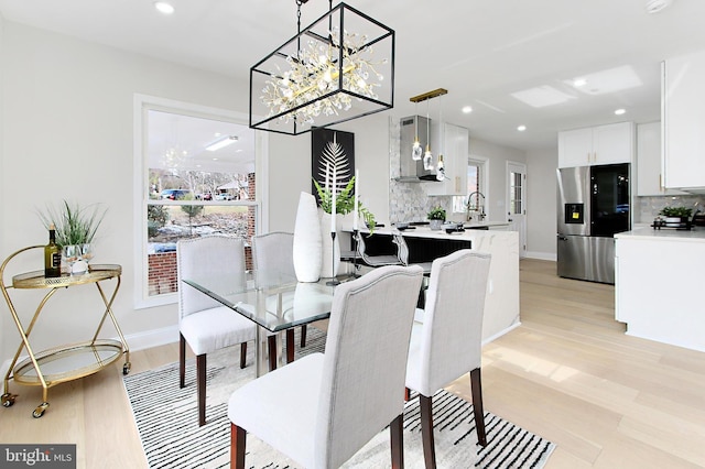 dining room with light hardwood / wood-style floors and sink